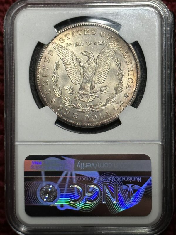 A silver dollar is on display in an old case.