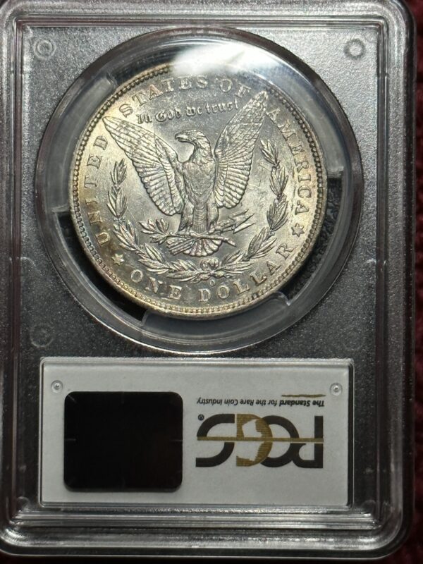 A silver dollar is on display in a case.