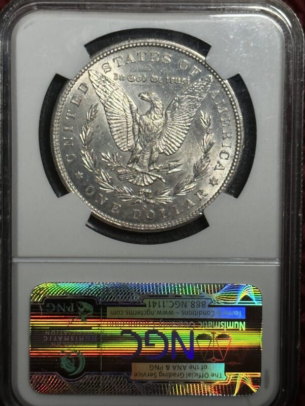 A silver dollar is on display in a case.