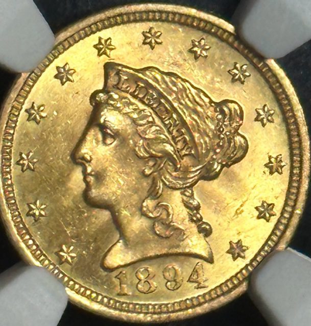 A gold coin with a woman 's face on it.