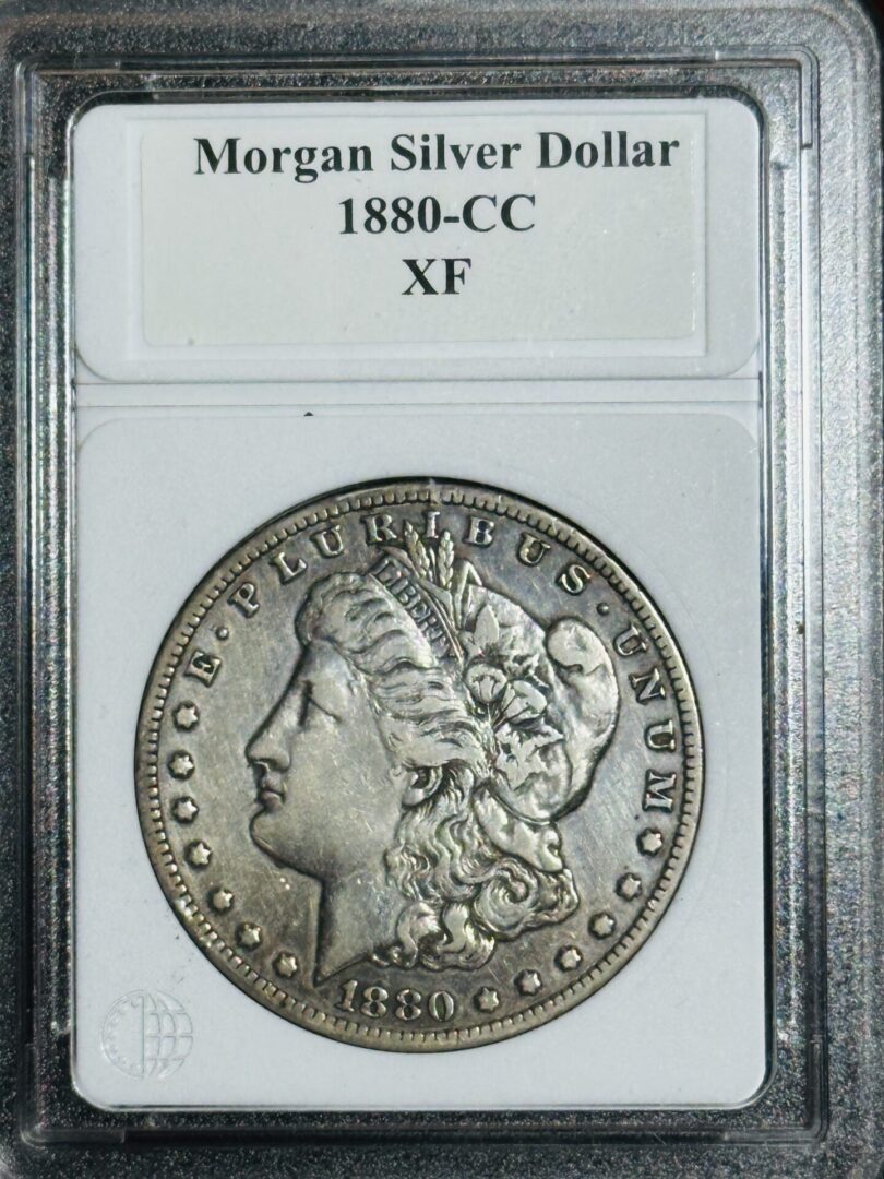 1880-CC Morgan Dollar VF30 coin, in a protective case, featuring a profile of liberty on the obverse.