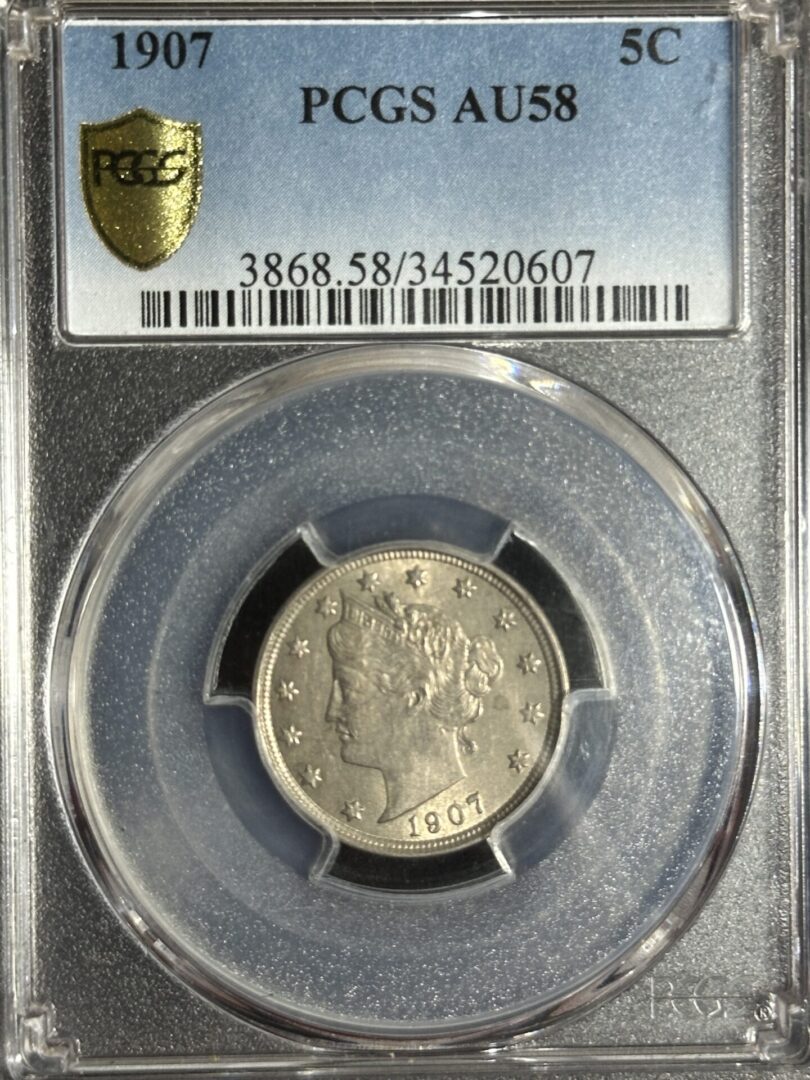 A 1907 Liberty Nickel PCGS AU58, enclosed in a transparent protective case with grading information displayed at the top.