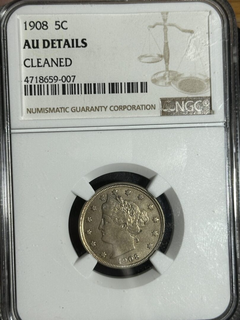 A 1908 Liberty Nickel NGC AU details coin graded as "au details cleaned" by ngc in a secured display case, featuring a woman's profile on the coin.