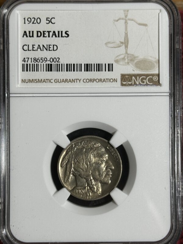 A 1920 Buffalo Nickel NGC AU details coin with the profile of a native american, labeled as "au details cleaned" by the numismatic guaranty corporation, encased in a protective holder with a barcode.