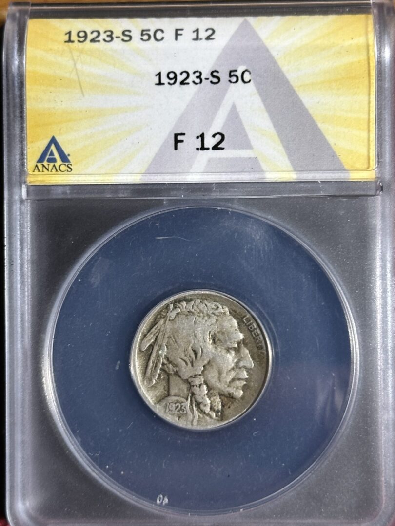 1923-S Buffalo Nickel ANACS F12 displayed in a blue holder with label, set against a light blue and yellow background.