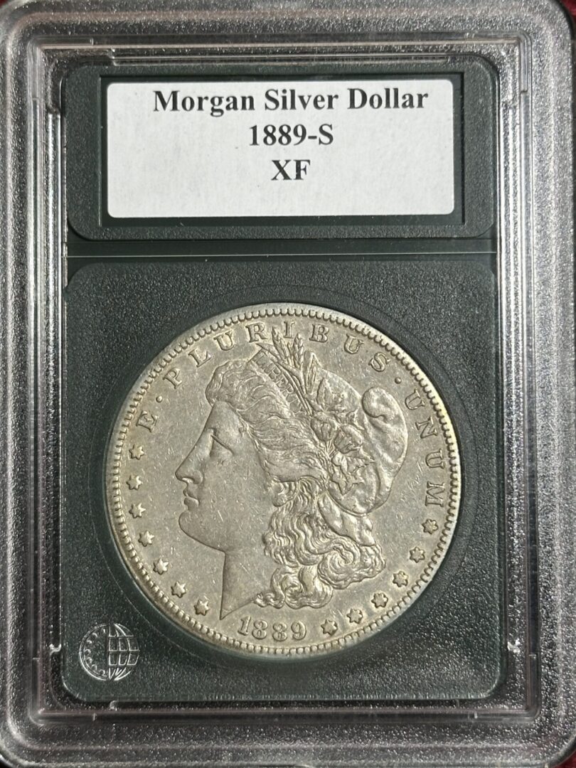 A 1889-S Morgan Dollar XF45 coin encased and labeled.