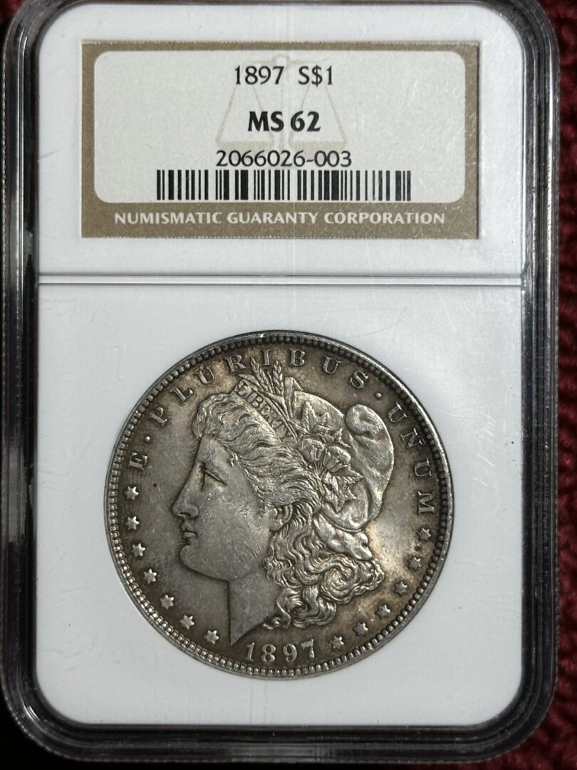 A 1897 Morgan Dollar NGC MS62 coin encapsulated in a labeled clear holder.