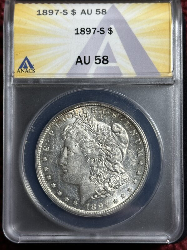 An 1897-S Morgan Dollar ANACS AU58, encased in a protective ANACS holder, showing detailed features of Lady Liberty's profile.