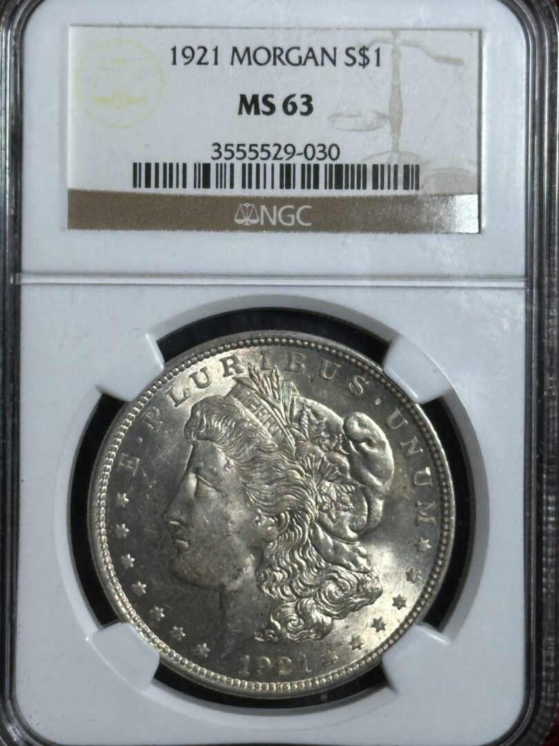 A 1921 Morgan Dollar NGC MS63 in a grade holder, featuring a clear view of the coin's obverse with liberty's profile.