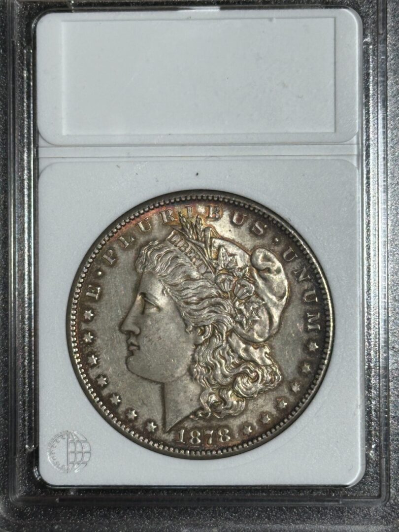 An 1878-S Morgan Dollar AU58 featuring lady liberty's profile, encased in a protective holder.