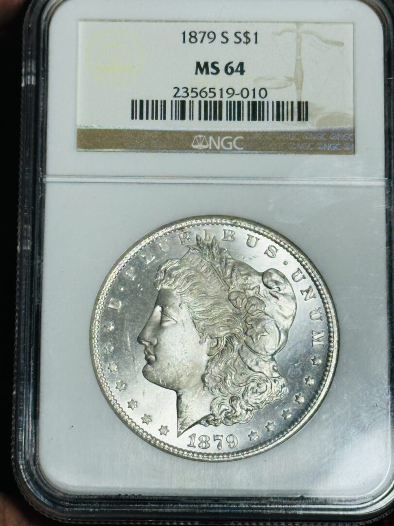 An 1879-S Morgan Dollar NGC MS64 in a protective case, displayed with grading label from NGC.