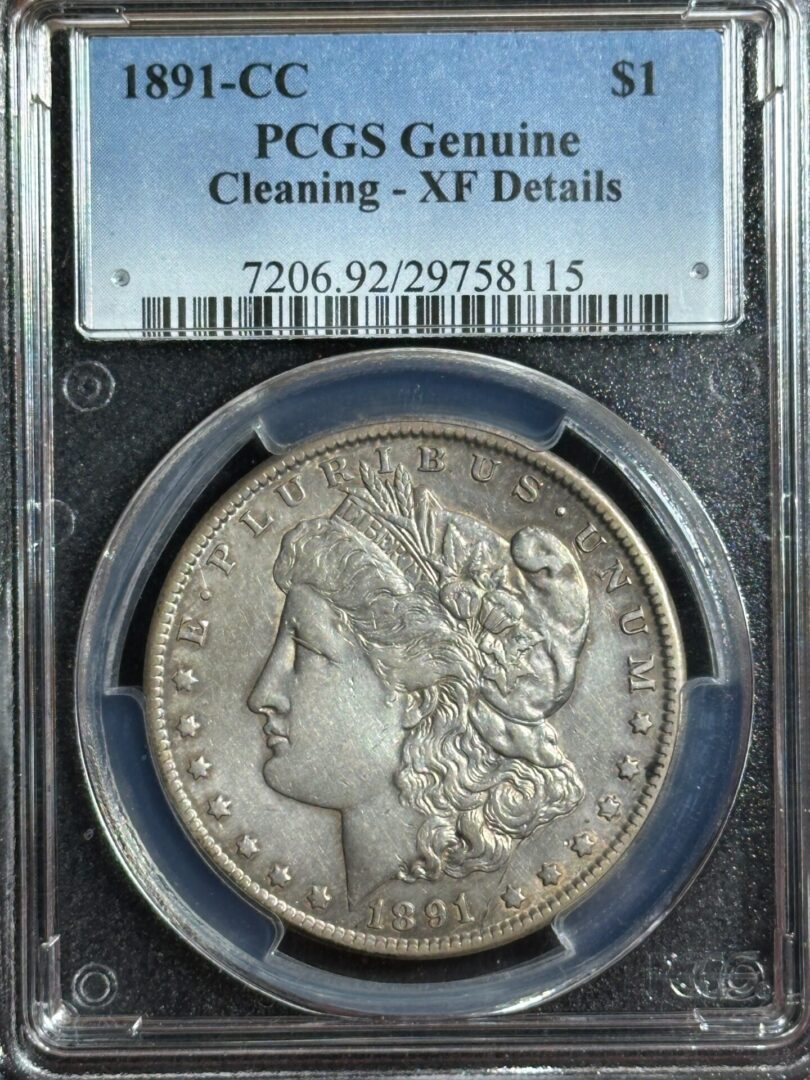 1891-cc morgan silver dollar in a pcgs holder labeled "genuine - cleaning - xf details," showing the coin's obverse with a liberty head design.