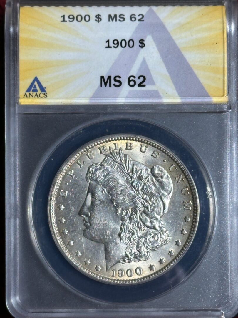 A 1900 morgan silver dollar graded ms 62 by anacs, encased in a protective holder with label showing details on the top.