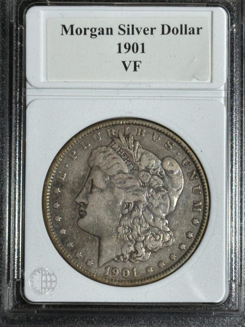 A 1901 morgan silver dollar graded vf, encased in a protective holder with labeling at the top.