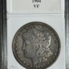 A 1904 morgan silver dollar graded vf, encased and labeled for preservation and display.