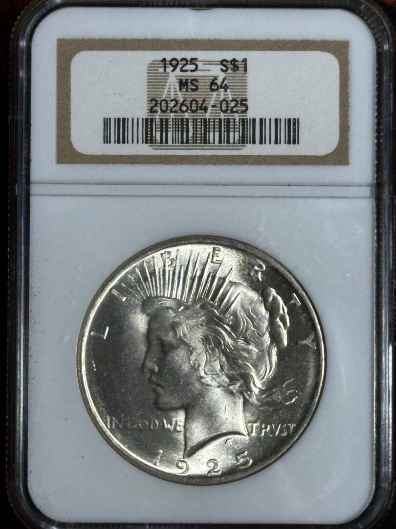 1925 silver dollar coin with lady liberty’s profile, labeled and graded ms 64 in a sealed protective case.