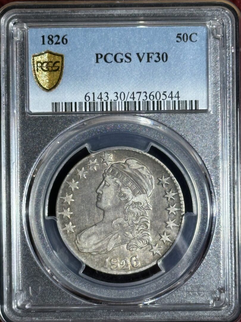 A 1826 Capped Bust Half Dollar PCGS VF30 coin, featuring a profile portrait of lady liberty, encapsulated in a clear protective case.