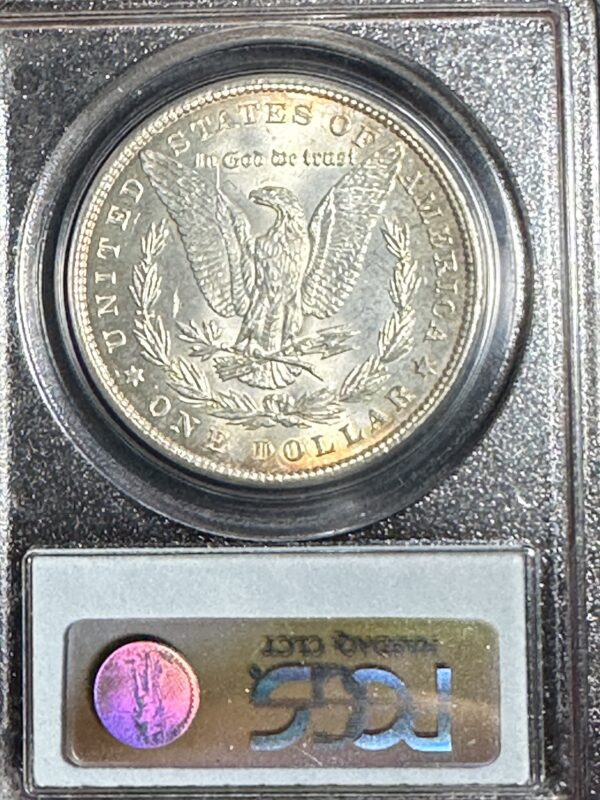 Close-up of a 1886 Morgan Dollar PCGS MS63 encased in a protective circular holder, with a certification label below it.