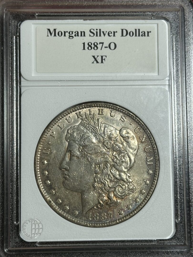 1887-O Morgan Dollar XF45 displayed in a case, featuring the head of liberty.