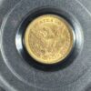 Gold coin with eagle and shield design.