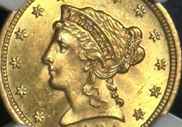 A gold coin with a woman 's face on it.